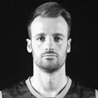 A man wearing a dark, athletic V-neck top, representing customized sportswear.