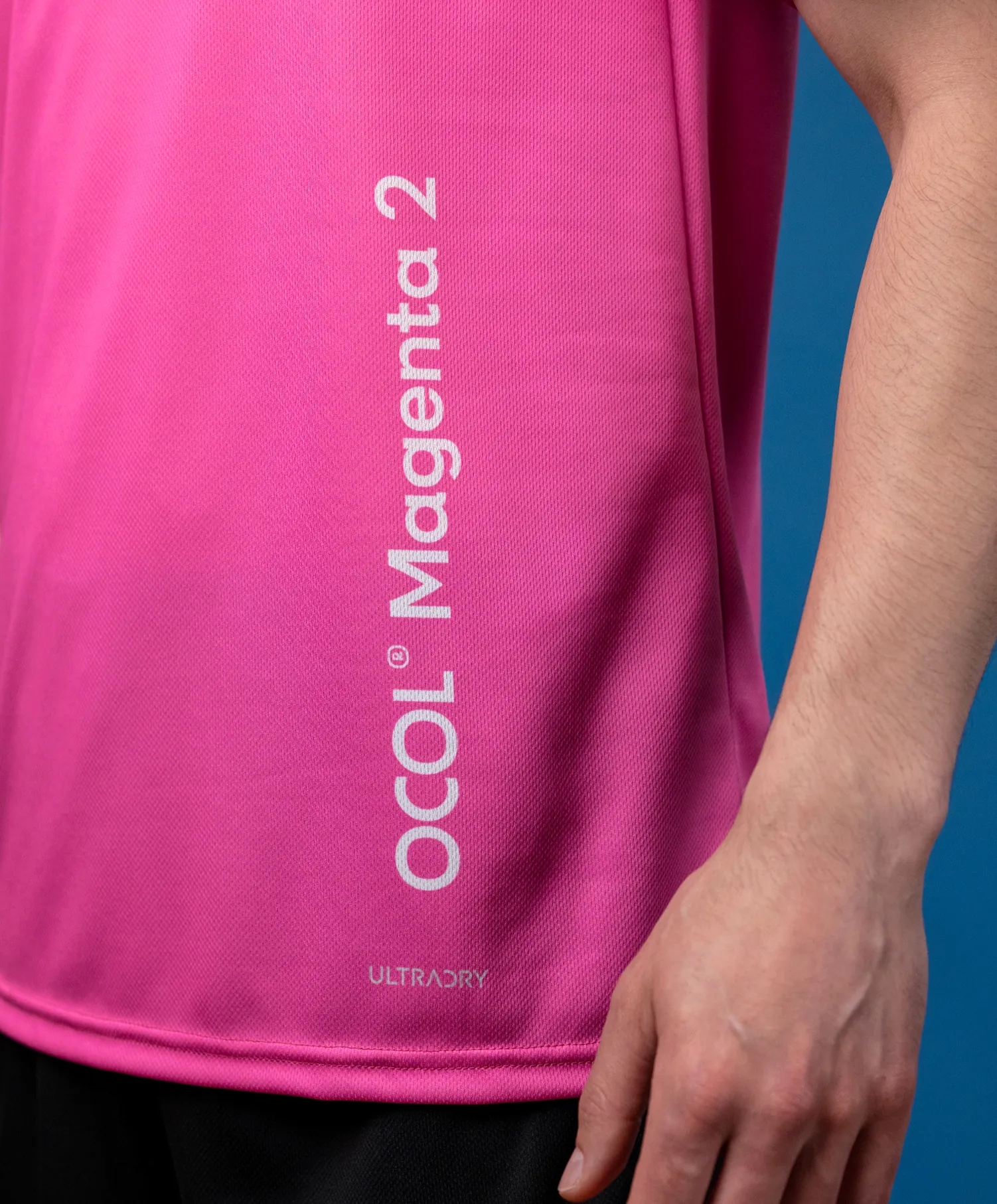A pink sports top featuring a logo and the text 'Magenta 2'.