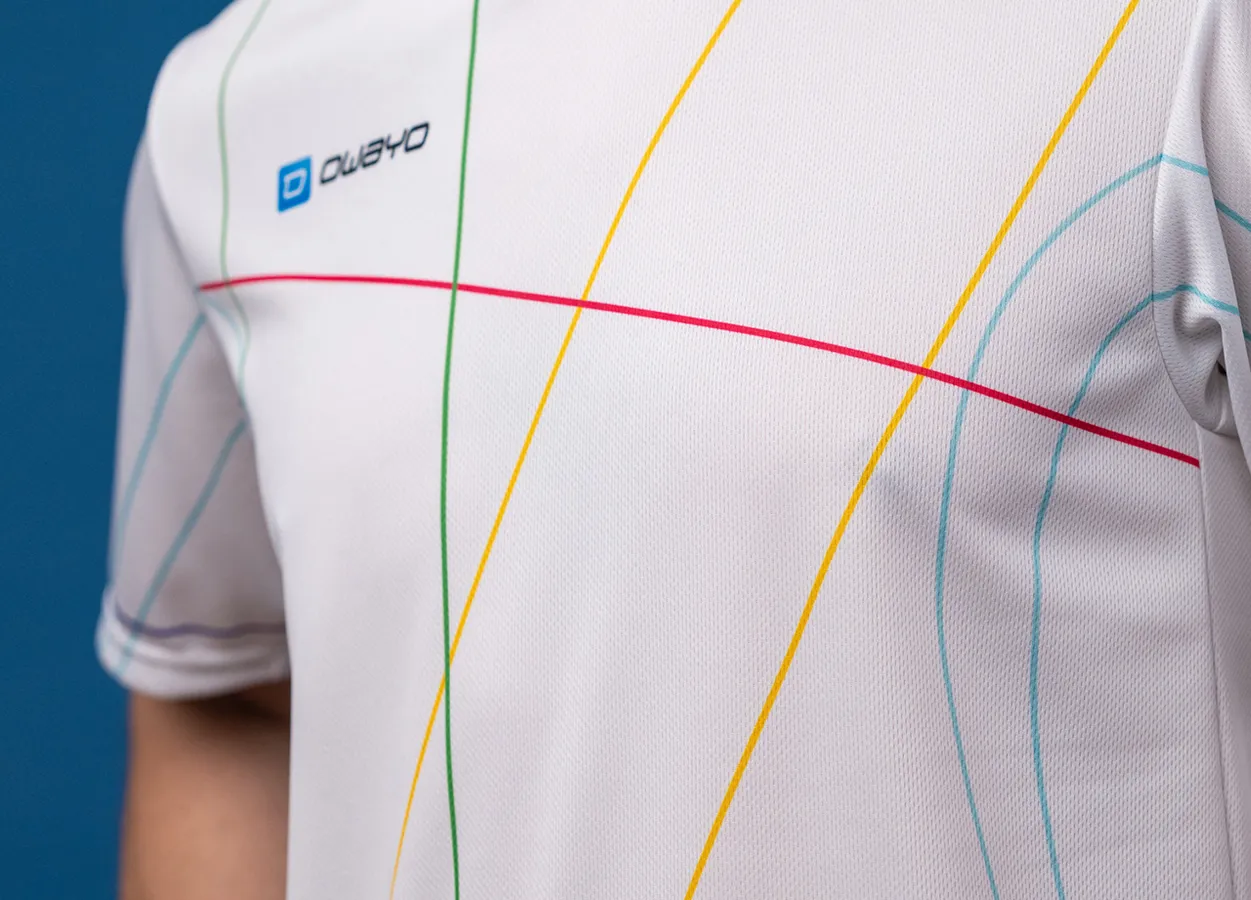 A close-up view of a white sports shirt featuring colorful lines in red, yellow, green, and blue.