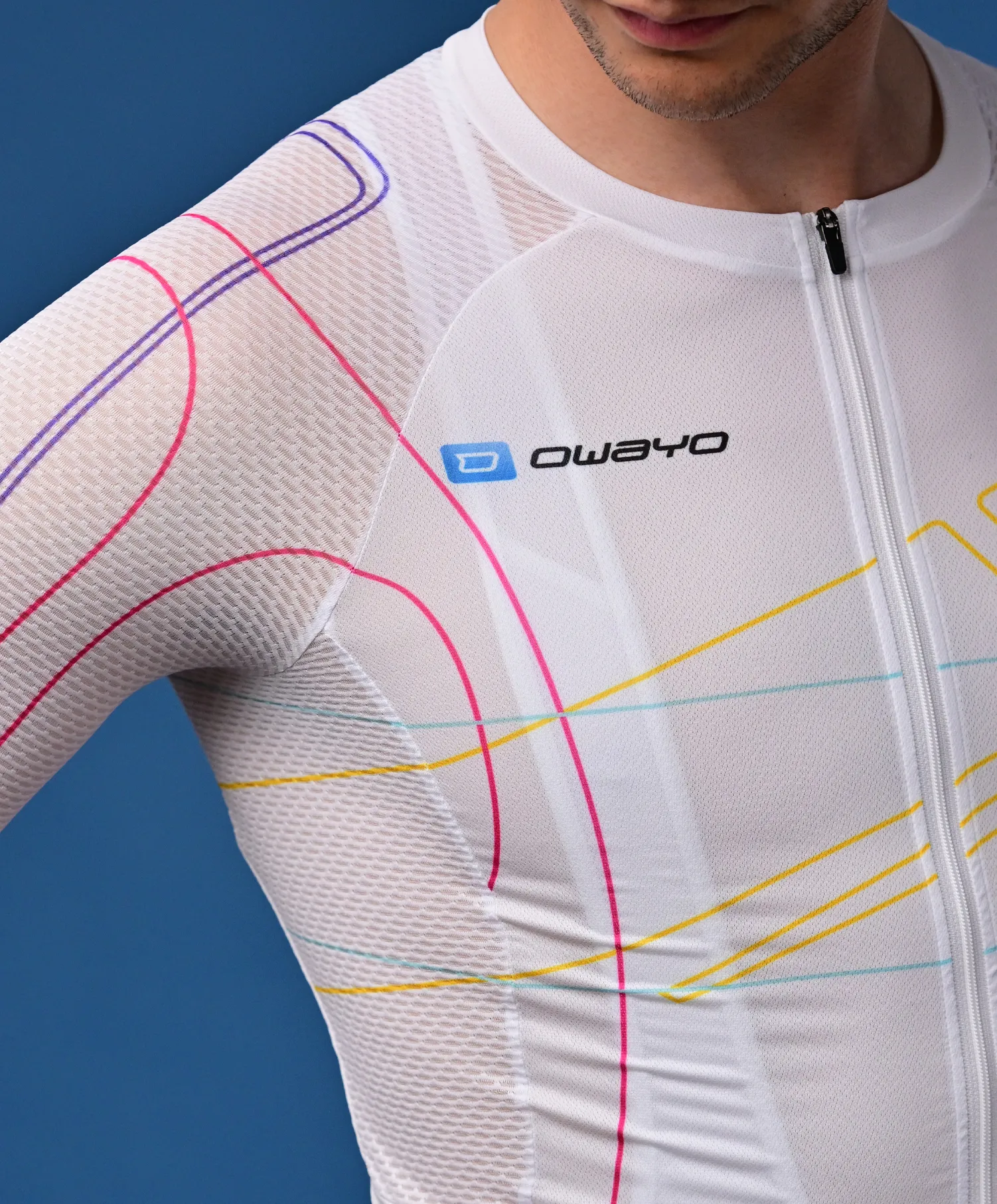 A man wears a white, breathable sportswear top by owayo with colorful lines and a front zipper.
